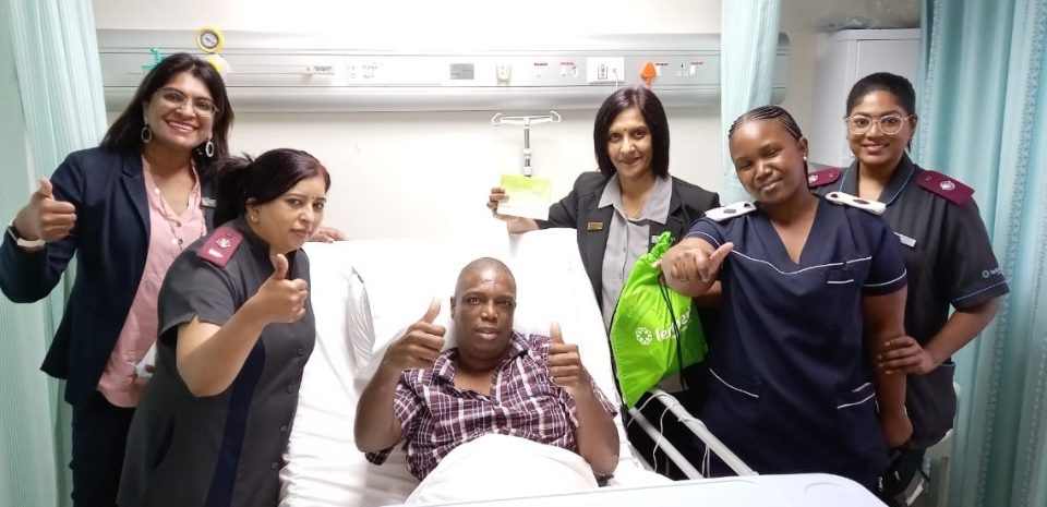 Doctors and nurses smiling with recovering patient
