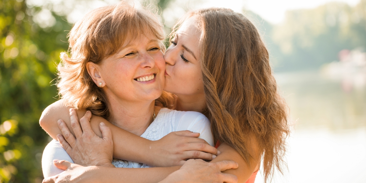 daughter kissing mother on cheek