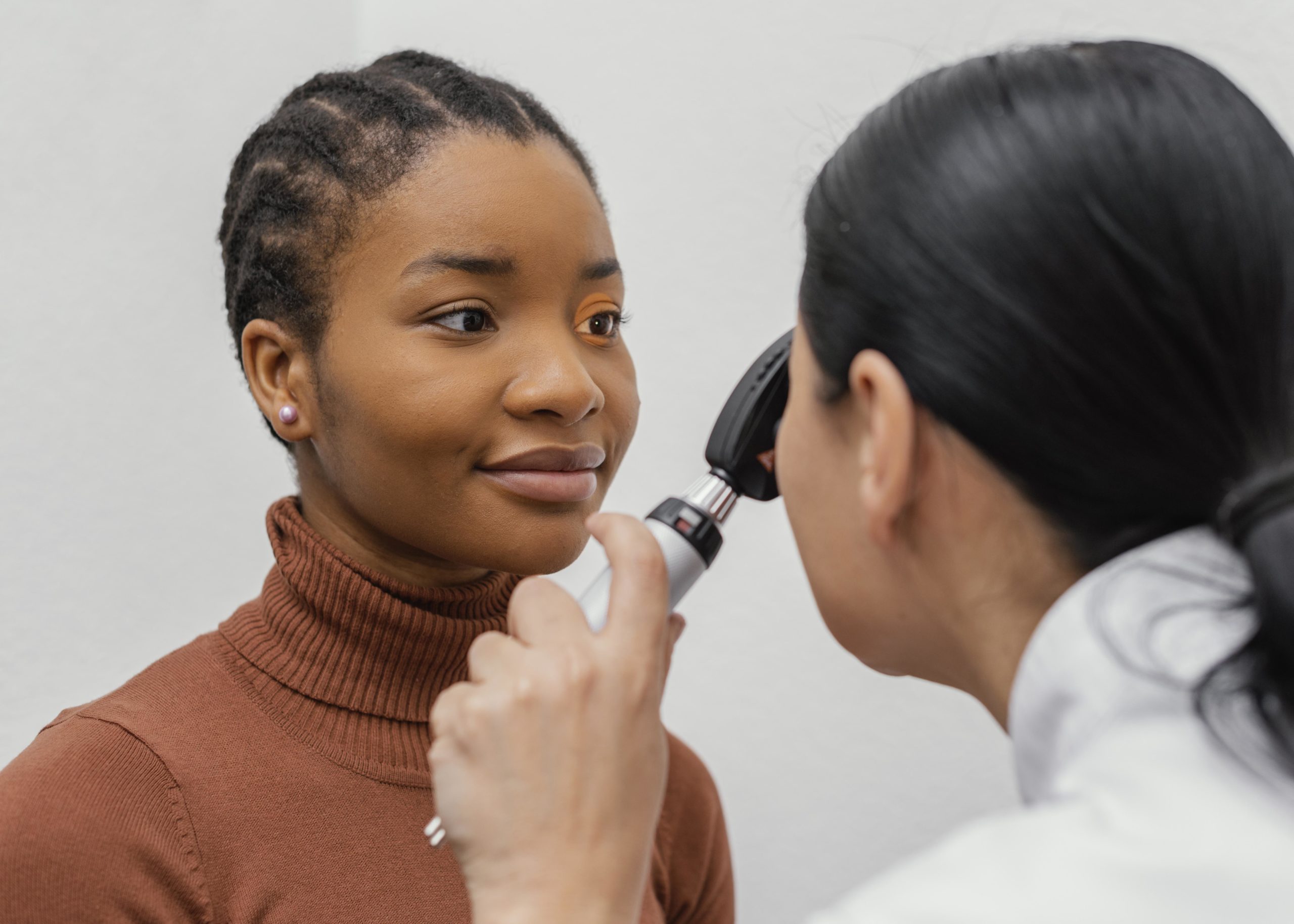 close up doctor checking patient eye