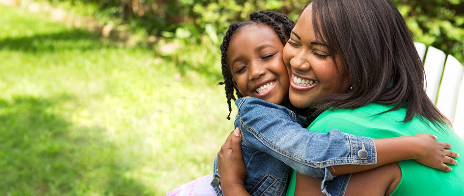 Mother and daughter happily hugging