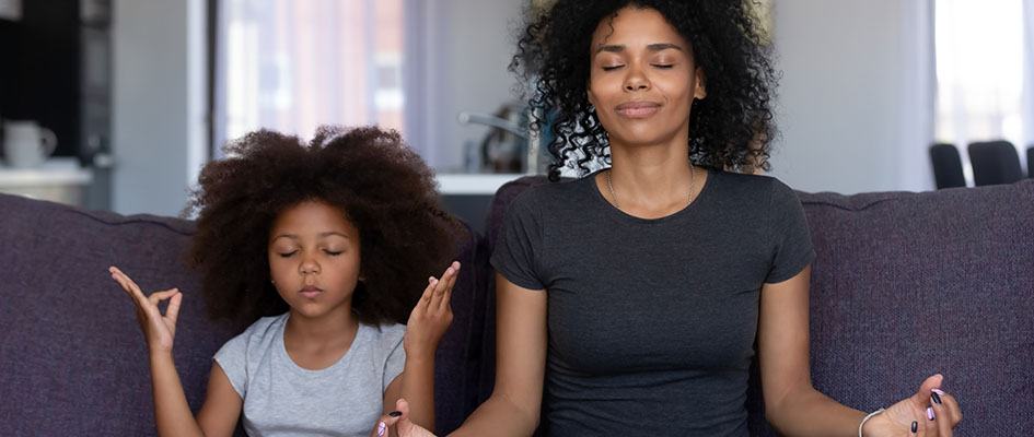 mother and daughter meditating
