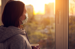 woman watching sunrise with mask on