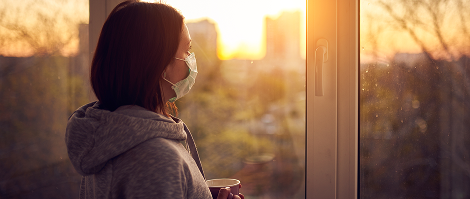 woman watching sunrise with mask on