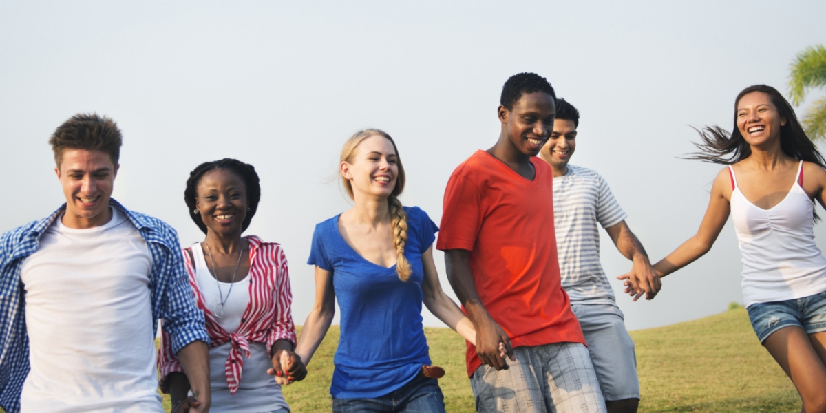 students laughing and hold hands